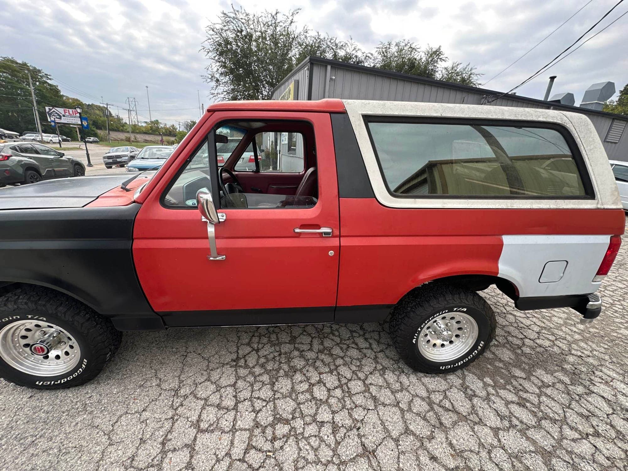The Bronco in two-tone red with the rear panel still being refinished